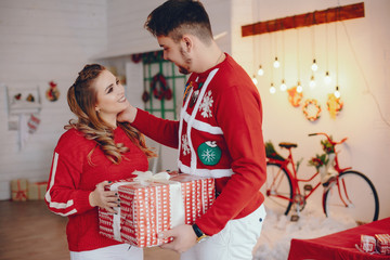 Wall Mural - Family standing in the studio. Blonde near Christmas tree. Pregnant woman with her husband