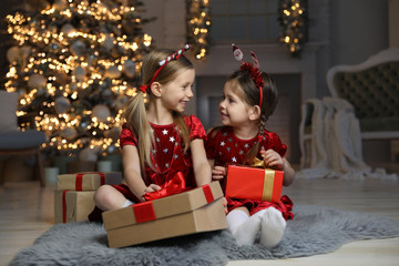 Poster - Cute little children with Christmas gifts in living room