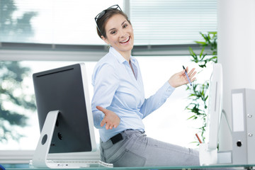 excited woman working at desk in office