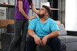 © New Africa - Woman comforting her depressed overweight friend at home