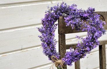 Wall Mural - Lavender wreath in the shape of a heart on a chair close-up