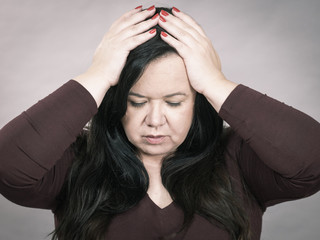 Worried woman having painfull headache