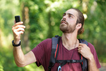 Hiker Searching A Mobile Phone Signal