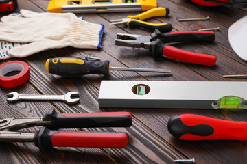 Different modern construction tools on wooden background