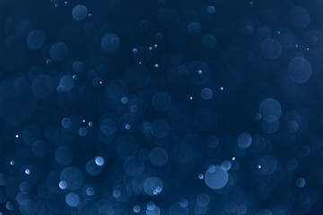 abstract sparkle bokeh light effect with navy blue background