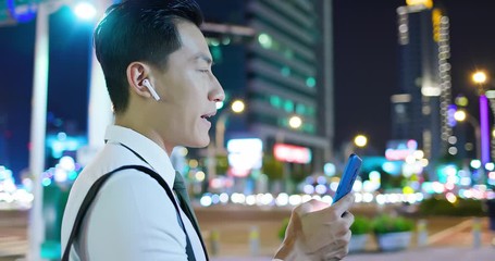 Wall Mural - asian man wear wireless earbuds