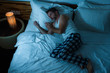 © TheVisualsYouNeed - dramatic lifestyle portrait of young attractive sad and depressed man lying on bed at night feeling stressed and desperate suffering depression problem in sadness and pain