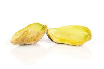 Group of two halves of salted pistachio isolated on white background