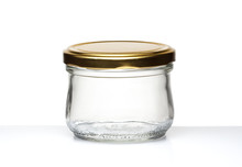 Small Glass Empty Jar With A Metal Lid On A White Surface