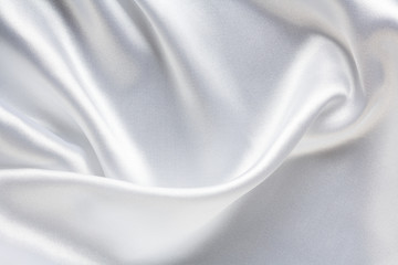 white silk satin fabric with large folds, elegant abstract background