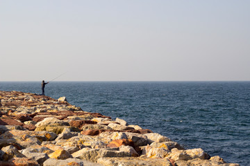 people on breakwater