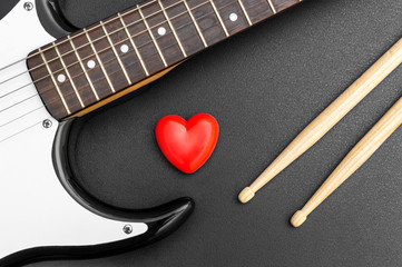 Wall Mural - Red heart with guitar and drumsticks on black. Love music.