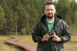 Naturalist studies the life and behavior of wild birds and animals in a nature reserve