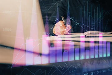 Double exposure of businessman with laptop and stock market forex chart.