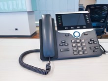 IP Phone Device On Work Office Table Desk Background. Communication Technology To Connect And Call For Business Use In Digital Era In Corporate Company Use. Professional Device For Call, Conference.