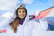 © ZoomTeam - Portrait of beautiful woman with ski and ski suit in winter mountain.