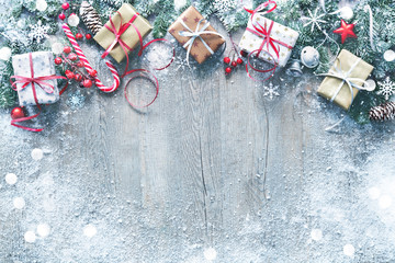 Wall Mural - christmas and new year background with fir branches, gift boxes, ornament and snowfall