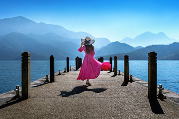 Wall Mural - Beautiful girl walking at Sun Moon Lake in Taiwan.