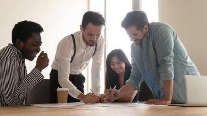 Wall Mural - Multinational businesspeople managing company finances thinking together at group meeting