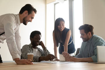 Wall Mural - Diverse colleagues make summarizing of financial information together in boardroom