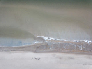 Wall Mural - seaside beach with water covered in fog mist