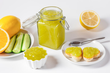 Wall Mural - Homemade delicious cucumber jam with lemon and heart shaped toast on white background.