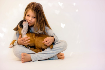 Poster - pretty little girl playing with her new puppy