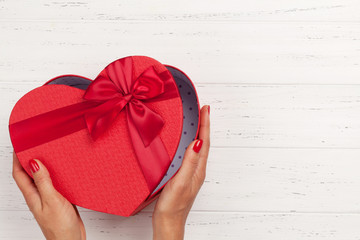 Woman hands holding gift box