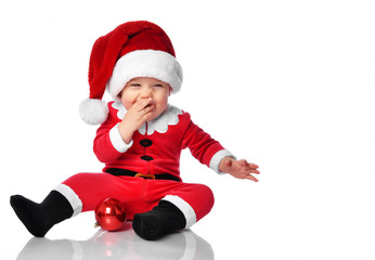 Little child boy toddler in santa claus christmas costume and hat happy smiling ready to celebrate new year party