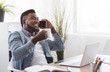 © Prostock-studio - Black businessman having coffee break and taking on phone in office