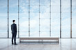 © Who is Danny - Businessman standing in empty spacious interior