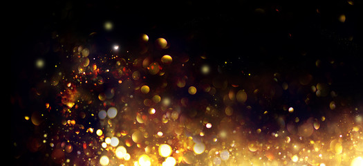 Wall Mural - golden christmas and new year glittering stars swirl on black bokeh background, backdrop with sparkl