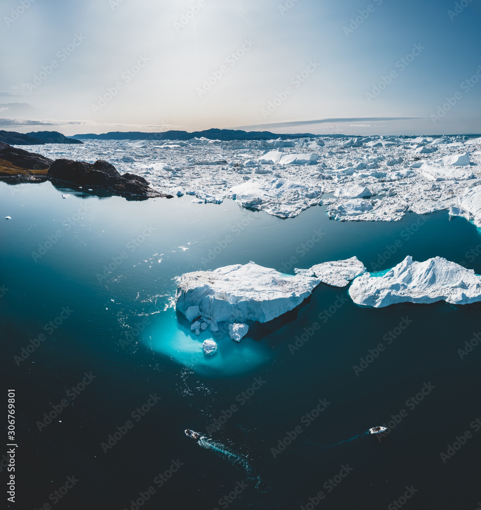 Iceberg and ice from glacier in arctic nature landscape in Ilulissat,Greenland. Aerial drone photo of icebergs in Ilulissat icefjord. Affected by climate change and global warming. - obrazy, fototapety, plakaty 