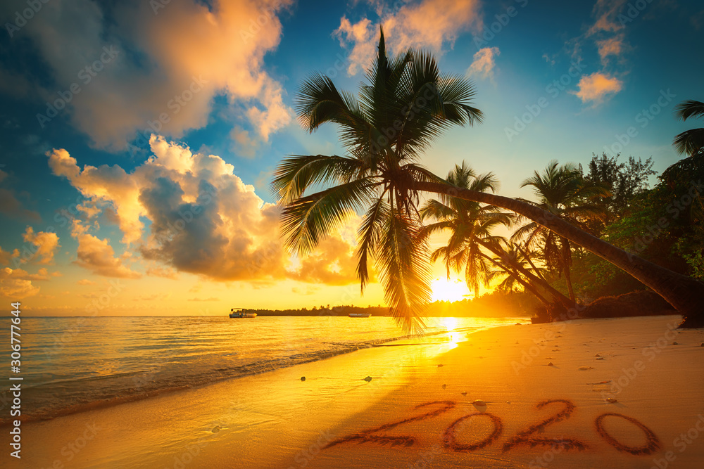 Happy New Year 2020 concept, lettering on the beach. Sea sunrise. - obrazy, fototapety, plakaty 