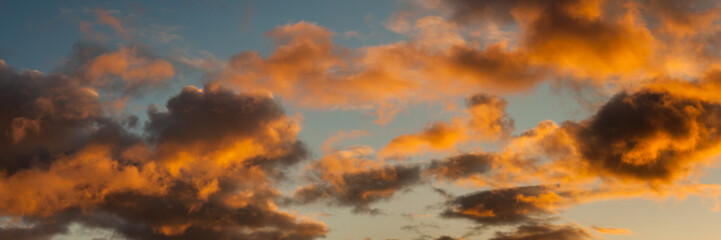 Wall Mural - panoramic sky view with clouds backlit by bright sunlight