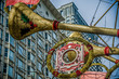 Large, Gold Trumpet decorations with red stars outside department store at Christmas