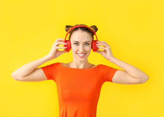 Poster - Beautiful young woman listening to music on color background