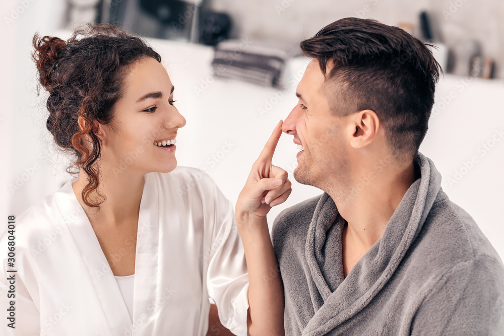 Happy young couple in bathroom at home