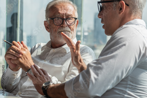 Cuadros en Lienzo senior board executive having business conversation with businessman in office