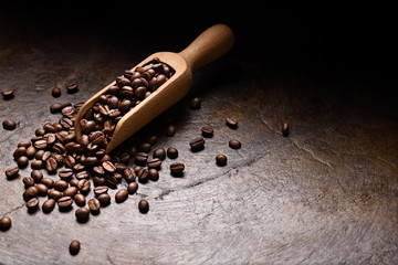 Wall Mural -  Coffee beans in wooden spoon on rustic background