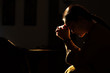 © PORNCHAI SODA - depressed women sitting in the low light church and praying, International Human Rights day concept