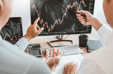 investment stock market entrepreneur business team discussing and analysis graph stock market tradin