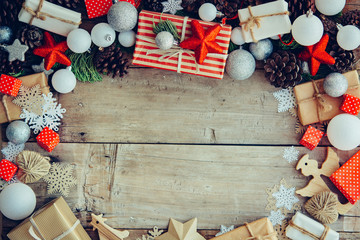 Wall Mural - Christmas background with gift boxes and decorations on the wooden table.