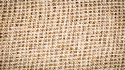 Cotton woven fabric background with flecks of varying colors of beige and brown. with copy space. office desk concept, Jute hessian sackcloth natura / Hessian sackcloth burlap woven texture background