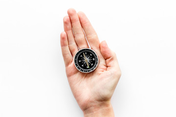 Wall Mural - Choose direction concept. Compass in hand on white background top view copy space