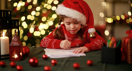 Sticker - happy child girl writing letter santa home near Christmas tree.