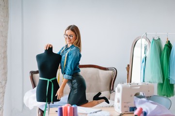 Fashion designer working on her designs in the studio