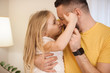 © Strelciuc - Close up of a lovely little kid playing with her father at home. Cute little girl boxing with her father.