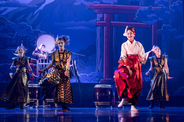 Wall Mural - Traditional Japanese performance. Group of actresses in traditional white and red kimono and fox masks dance on the stage.