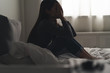 Leinwandbild Motiv Suffer from depression , mental health problem. asian young woman sitting on the bed feeling depressed.